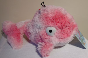 Pink whale soft toy with big eyes.