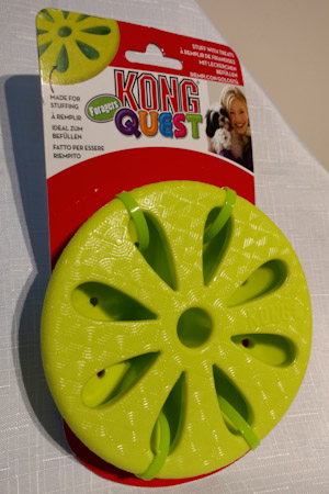 Round, green plastic disc with flower design cut into it