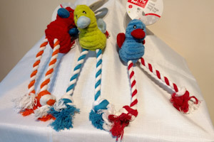 Three bird soft toys of various colours with long rope legs.  