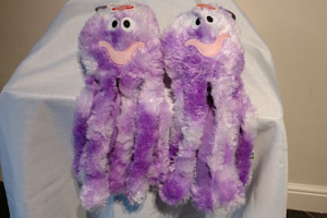 Two purple octopus soft dog toys.