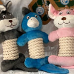 Three Ancol Rope Bellies dog toys, a grey squirrel, a blue platypus and a pink rabbit